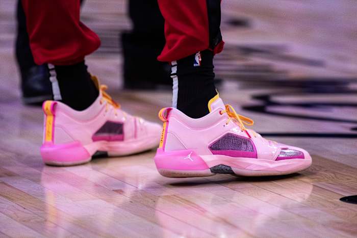 View of Bam Adebayo's pink and purple Air Jordan shoes.